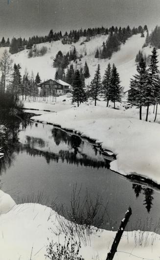 A Laurentian Chalet nestles picturesquely in a postcard setting at Ste