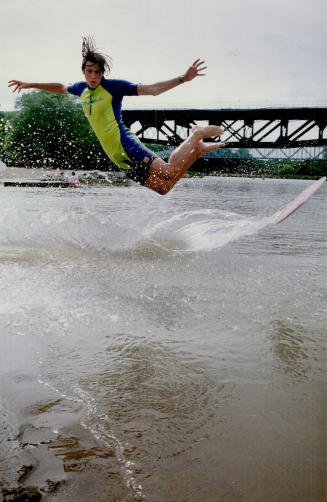 Flying high above the Rouge River, Skim-boarder Tim Van Rossem, 16, puts on an aerial show at the mouth of the Rouge River. He was demonstrating the t(...)