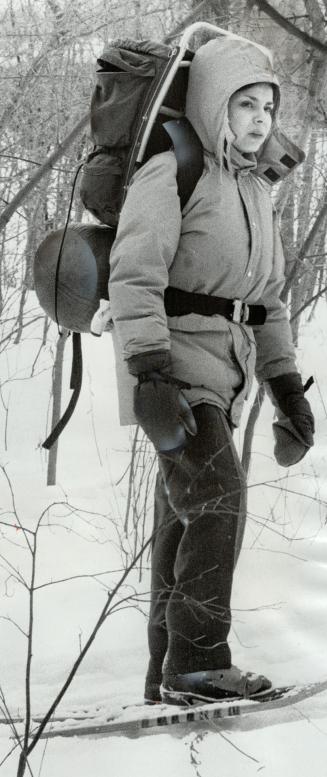 Protected against the elements, Paulette Bellemore, 22, is well bundled against the cold as she sets out through the bush. Winter campers sing the pra(...)