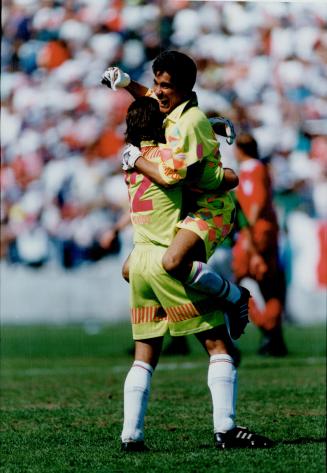 Cup Bound: Mexican goalkeeper Jorge Campos leaps into the arms of Alejandro Barrera after 2-1 victory