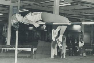 Up and over. Bridgette Bittner of Elliot Lake shows fine form in backward leap over high jump bar at qualifying meet Saturday for The Star Maple Leaf (...)