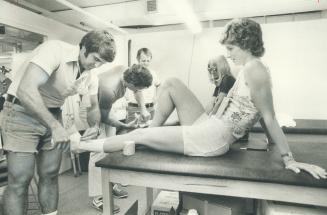 Canadian runner Joyce Yakubowich gets ankle taped during Olymp ic training in Montreal