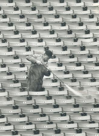 It won't be long. Yep, it's that time of year again. Gord Johnston uses a pressure hose to clean the seats in the stands at the CNE Stadium to prepare(...)