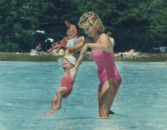 Hey baby, ain't you cool! Cindy Guthrie gives her 14-month-old son, Joshua, relief from the heat and huminity in the 6-hectare pool at Petticoat Creek(...)
