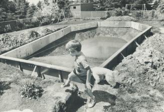 The mud hole in the backyard of the home of Peter and Margaret Hetner in Agincourt, where their son, Ryan, 4, plays, was to have been swimming pool an(...)