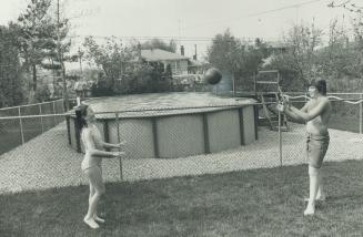 The family of Mr. and Mrs. Douglas Hall spends summers at their backyard pool