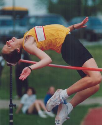 Up, up and over. Meghan Chandler curis her body like a comma, arches, grimaces - and clears the bar at the Central Regional track finals held in Oshaw(...)