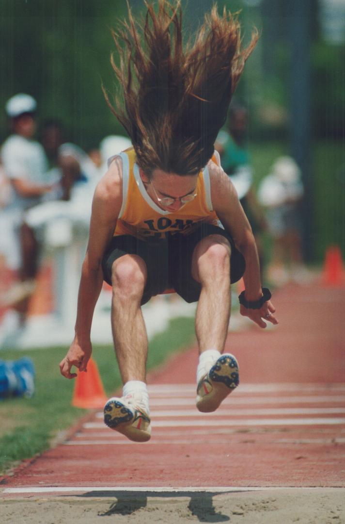 Jaz Everett of Monarch Park Collegiate faces some wind resistance in the track and field triple jump at Etobicoke Centennial Stadium yesterday. He finished 10th