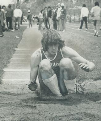 Woburn's Ken Felepchuk lands after making triple long jump of 43 feet, 8 inches to win senior event during TDIAA track and field championships at Birc(...)