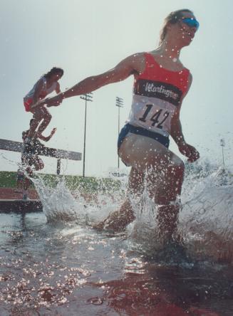 Making a splash at track. Martingrove's Ken Thorarinson is up to his knees in a pool of water during the steepchase event yesterday at the Etobicoke o(...)