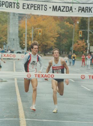 Fight to the finish. Steve Scott, right, outsprints fellow American Jeff Atkinson to the finish line in the Texaco Mile around Queen's Park Circle yes(...)