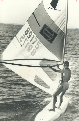 The only woman among eight people trying to be the first windsurfers to cross Lake Ontario, Sara Lee manages a smile at about the halfway point yester(...)