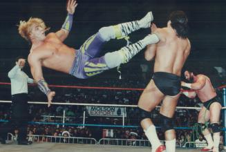 Shawn Michaels of the Rockers delivers flying kick to Paul Roma of Power and Glory during WWF card yesterday at the Gardens. Roma's partner, Hercules,(...)