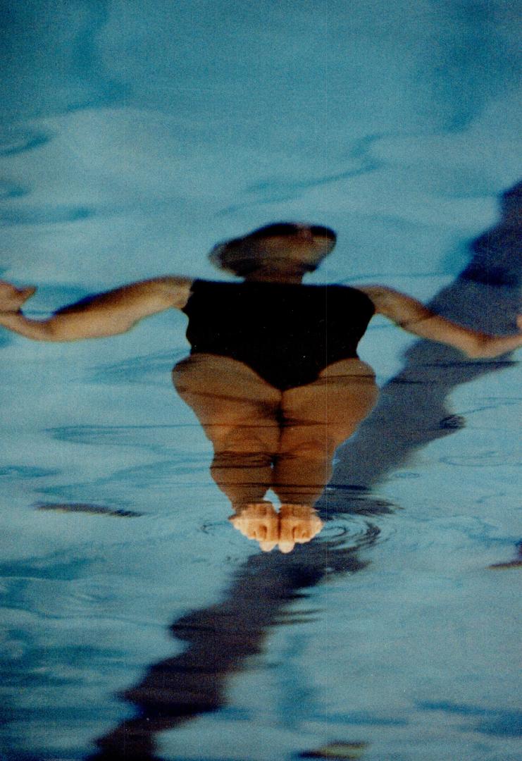 The finer points of synchronized swimming include the precise curl of clenched toes, poking through the water's surface (above). A related sport is th(...)