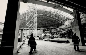 Nov. '88. The SkyDome begins to take shape, left, its mass dwarfing and shading workers