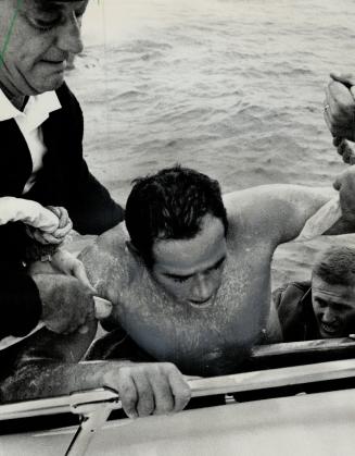 Exhaustion and agony are evident on face of Egypt's Abdel Latif Abou Heif as he is helped from Lake Ontario in CNE marathon swim