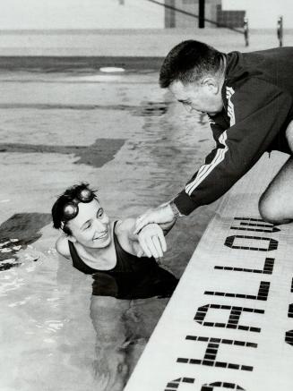 In training for a 35-to-50-mile swim of Lake Ontario, nurse Pat Stoffels gets pointers from her coach, Richard Lough, yesterday at the Fitness Institu(...)