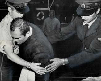 So cold he couldn't bend, Mahomed Zaitoon of Egypt was helped ashore by ambulance men