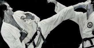 A longer reach enables Park Jong Soo (left), a seventh-degree black belt in Taekwon Do from Toronto, to best Peter Gretes of Windsor on this move at M(...)