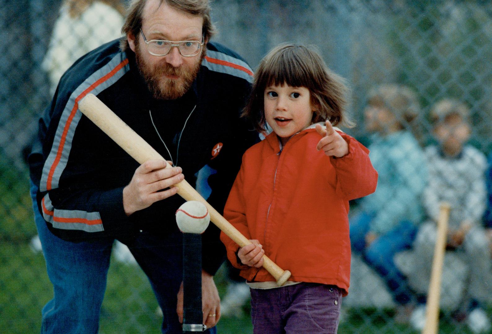 Getting into the swing of things in tee-ball at Pape Park, Amy Bippus, 4, gets batting tip from coach John Hodgson (above) while, at left, parent Sue (...)