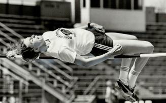 Louise Hanna of University of Toronto track club leans backward over high jump bar during Saturday's Ontario Track and Field Association all-comers' m(...)