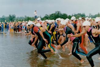 Off and swimming: Competitors head for water as part of triathlon at Guelph Lake conservation area