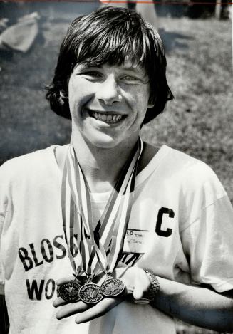 Clarence Bates displays gold medals won at Special Olympics