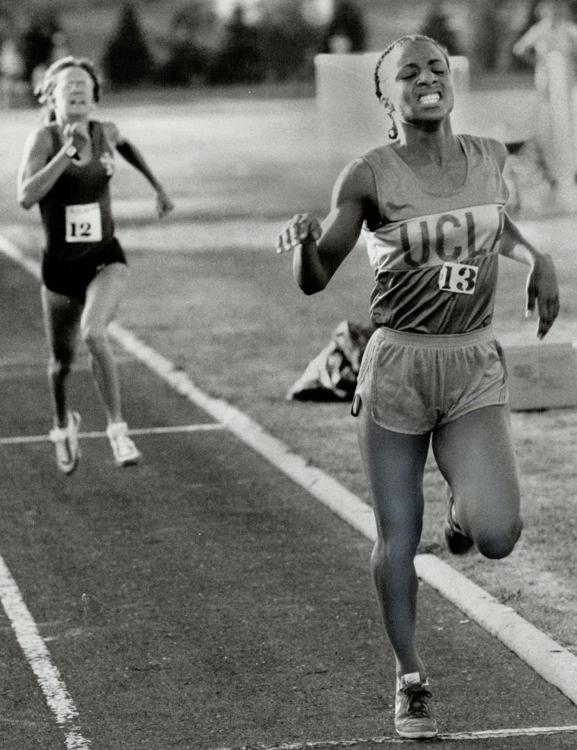 Agony of victory: With her teeth clenched after the rigors of the 1,500-meter run, Michelle Bush of UCLA crosses the line first at the second annual Variety Village Track Classic