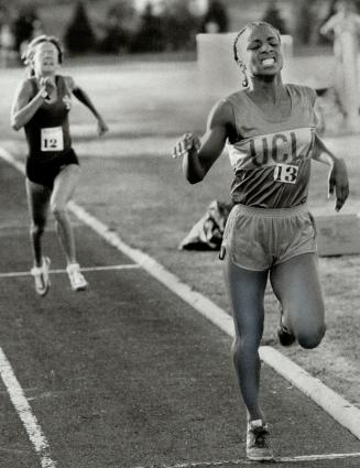 Agony of victory: With her teeth clenched after the rigors of the 1,500-meter run, Michelle Bush of UCLA crosses the line first at the second annual Variety Village Track Classic