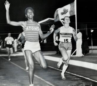 Cheryl Toussaint (left) of new York signals end to five straight losses by beating Ottawa's Glenda Reiser in 800-metre feature of Metro Toronto Police(...)