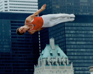 Alexander Danilchenko of the Soviet Union demonstrates his prowess on the trampoline over Harbourfront yesterday