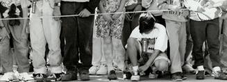 Some of an estimated 3,500 walkers wait at the starting line to follow a 10-kilo-metre (6