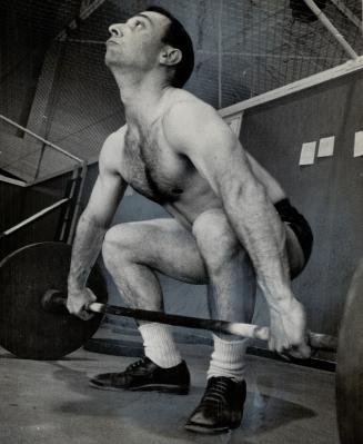 Straining every muscle, Syd Charendoff prepares to lift barbell in workout at Northern YMHA