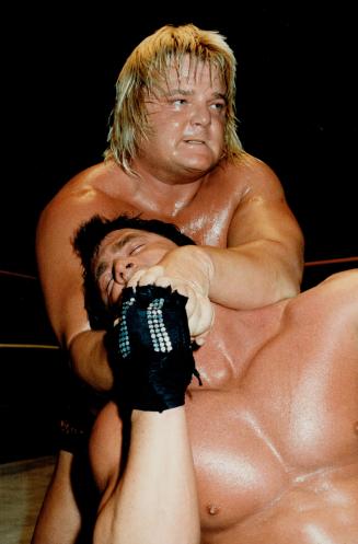 Blond bomber Greg (The Hammer) Valentine has his paws full with Brutus (The Barber) Beefcake