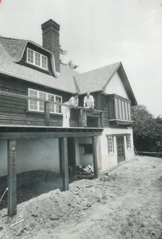 Actress Monica Haldane, and stage designer Kaare Heartness look out from the balcony of the Tudor country manor house their company has just built in (...)