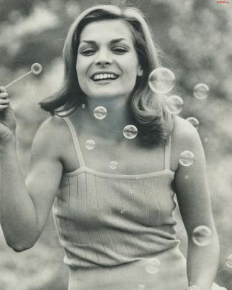 Struck by spring fever, actress Susan Keller expresses joy by blowing bubbles