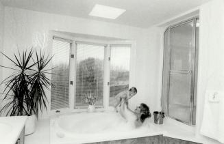 Bubble bath: Actress Sherry Miller relaxes in her over-sized whirlpool tub with baby Shanda