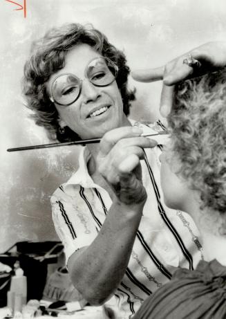 Artist at work, Irene Redford makes up the face of actress Luba Goy