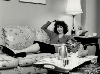 Weary but still game at the end of the day, author Beauman puts her feet up after completing an interview with The Star's Kathy English, left. Bantam (...)