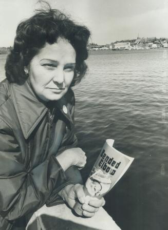 Eleanor Jacobson sits beside Lake of the Woods with her book Bended Elbow, denounced by the Ontario Human Rights Commission