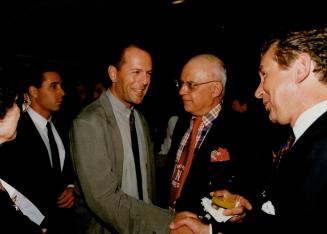 Bruce Willis, Hollywood Reporter Social columnist George Christie, right Hans Gerhardt general manager Sutton place Hotel