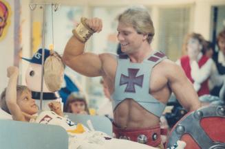 He-Man flexes his muscles at Sick Kids, He-Man, the popular cartoon character, appeared in flesh and blood at the Hospital for Sick Children yesterday