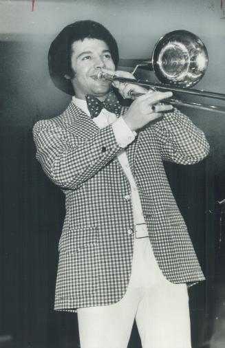 Russ Little, trombonist and music writer, is comfortable in red, white and blue polyster jacket, white baggies, white shirt and bow tie