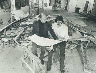 Inspecting plans for the new Toronto home away from home for Chicago's Second City Theatre is Bernard Sahlins (left), producer-director, and actor Joe Flaherty. Theatre is on Adelaide St