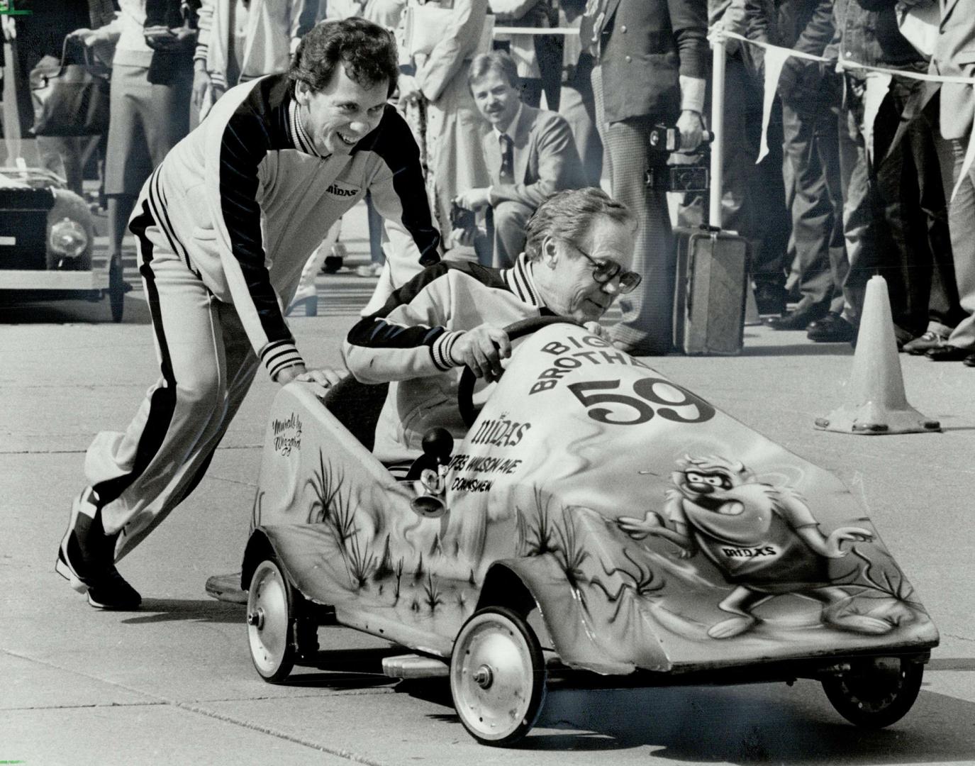 They're off!, CKEy's Eddie Luther steers his soapbox racer into the chicane, assisted by Bill Robinson, during the annual Big Brothers Celebrity Soapbox Derby yesterday at Nathan Phillips Square