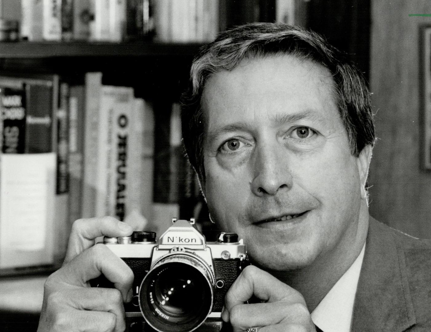 Another focus: Pat Murray checks out a camera at his North York home