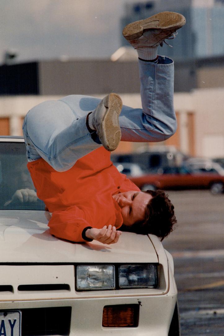 New breed of stuntman, Stuntman Ken Quinn, of Mississauga, gets 'hit' by a car in the parking lot at Square One shopping centre in Mississauga
