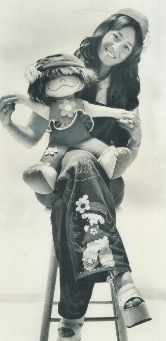 Chubby doll held by Vivian Greene, 26, is Rotunda, star of Miss Green's cartoon strip, Kisses, which appears in The Star and 20 other Canadian newspapers