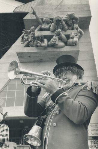 Toot salute: Bob Martin, a member of the Futz and his Band of Nuts troupe entertains members of the public who got a sneak preview of the SkyDome yesterday