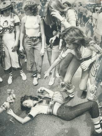 Heart and Excitement prostrated dozens of youngsters as about 2,000 Bay City Rollers fans swarmed outside CHUM radio station on Yonge St. yesterday tr(...)
